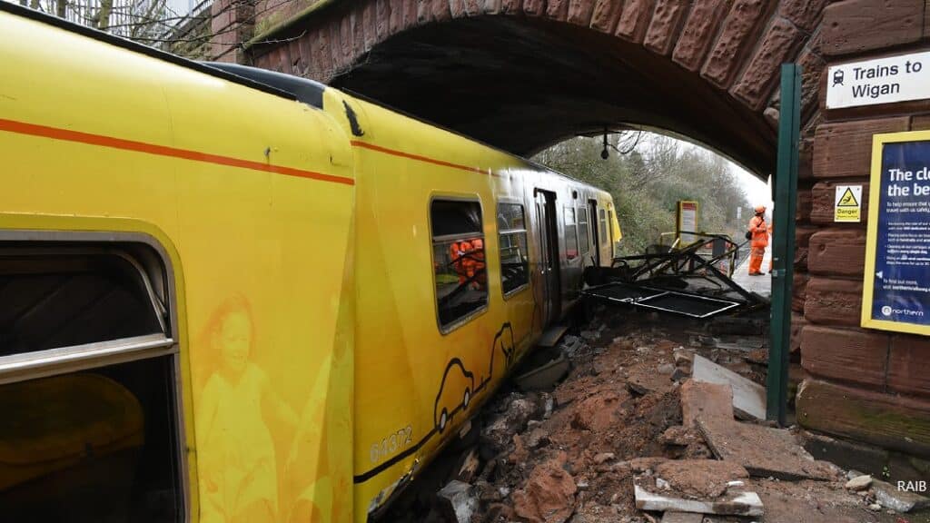 The train demolished the pedestrian walkway under the bridge